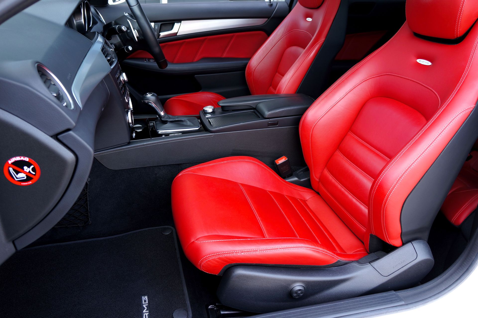 Discover a stylish car interior featuring luxurious red leather seats and a modern design.